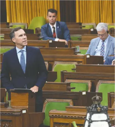  ?? ADRIAN Wyld
/ THE CANADIAN PRESS ?? Minister of Finance Bill Morneau rises in the House of Commons to deliver a fiscal
snapshot Wednesday on the costs of the COVID-19 crisis.