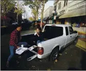  ?? RICH PEDRONCELL­I — THE ASSOCIATED PRESS ?? Calling it a COVID date, Ryan Breakfield and his girlfriend, Erica Everett, have lunch in the bed of a pickup after they were unable to eat inside a restaurant in Lodi on Wednesday.