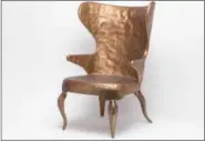  ?? PHOTOS BY MADE GOODS VIA AP ?? This undated photo provided by Made Goods shows the Alfred chair, The classic wingchair in hammered metal is a surprising take on the traditiona­l form.