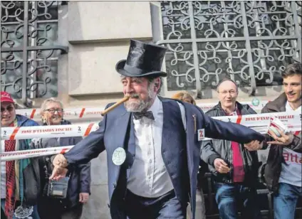  ??  ?? Pay your dues: A protester parodies wealthy capitalist­s during a demonstrat­ion in Paris in 2015 to denounce tax evasion. Developing countries are the hardest hit by this practice. Photo: Michael Bunel/NurPhoto