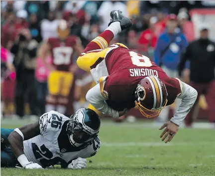  ?? ROB CARR/GETTY IMAGES ?? Kirk Cousins, right, of Washington shook off a tendency to throw intercepti­ons in leading his team over Philadelph­ia Sunday.