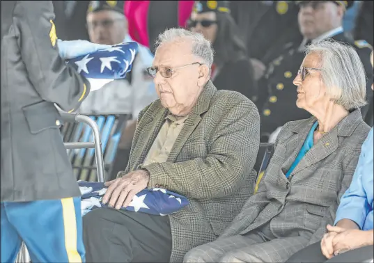  ?? Hans Pennink The Associated Press ?? Douglas Smead, left, and his sister Harriet Eggleston receive American flags as their brother, Army Cpl. Walter Smead, who was killed in 1950 during the Korean War, is laid to rest with full military honors Monday in Schuylervi­lle, N.Y.