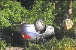  ?? Olivia Drake photo ?? Haddam fire crews were dispatched to a one-car rollover on Killingwor­th Road near Squabble Hollow Lane June 24. The driver, heading northbound on 81, struck a guardrail, which launched her vehicle about 60 feet forward. The vehicle flipped over upon impact with a tree, according to officials.