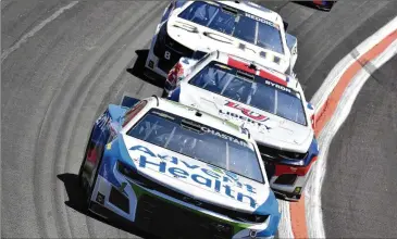  ?? HYOSUB SHIN/AJC 2022 ?? Ross Chastain leads the field during the Folds of Honor Quiktrip 500 NASCAR Cup race, which debuted a new surface at Atlanta Motor Speedway in March 2022.