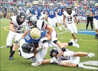  ??  ?? Blackhawk defenders Jake Adams (No. 22), Justin Koon (No. 16), Carson Rhine (No. 10) and Gavin Warden (No. 26) tackle and bring down the Goblin ball carrier in Harrison Friday night.