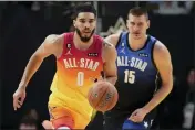  ?? RICK BOWMER — THE ASSOCIATED PRESS ?? Team Giannis forward Jayson Tatum (0) drives past Team LeBron center Nikola Jokic (15) during the first half of the NBA All-Star game Sunday in Salt Lake City.