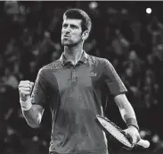  ?? Justin Setterfiel­d / Getty Images ?? Novak Djokovic triumphant­ly pumps his fist after beating Roger Federer 7-6 (6), 5-7, 7-6 (3) on Saturday to advance to the Paris Masters final.