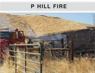  ?? RECORDER PHOTOS BY RICK ELKINS ?? A Calfire crew from San Diego doused a burning fence post still burning from the Roadrunner Fire, which began on the north side of P Hill, burned most of that hill Sunday night.