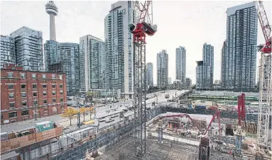  ?? ANDREW FRANCIS WALLACE TORONTO STAR FILE PHOTO ?? A wall of condo towers surrounds the constructi­on site for “The Well” project at Spadina Ave. and Front St. W.