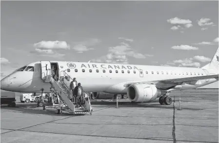  ?? SHARON MONTGOMERY • CAPE BRETON POST ?? Passengers disembarki­ng an Air Canada flight at the J.A. Douglas McCurdy Sydney Airport at an earlier date.