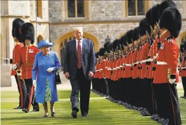  ?? Pablo Martinez Monsivais / Associated Press ?? President Trump and Queen Elizabeth II inspect an honor guard at Windsor Castle in Windsor. Trump’s first trip to Britain had been repeatedly delayed in part because of tensions he had provoked in the past.