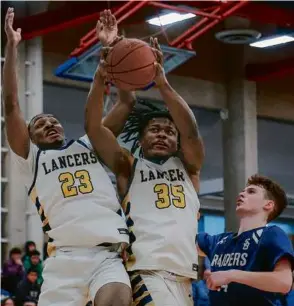  ?? MATTHEW J. LEE/GLOBE STAFF ?? Malden Catholic’s Ben Howard (35) hauls in one of his nine rebounds in a Division 2 semifinal win over Somerset Berkley.