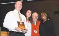  ??  ?? Charles County Public Schools human resource specialist Jeremy Campbell, left, accepts the Melwood Employer Award on behalf of the system on Wednesday at the second annual Charles County Job Developers’ Alliance employer award breakfast at New Life...