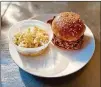  ?? WENDELL BROCK FOR THE AJC ?? Hero Doughnuts & Buns serves a stellar fried chicken sandwich. It’s paired here with the crunchy slaw.