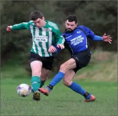  ??  ?? Stephen Casey of Oylegate United challenges Gavin Rafter of Caim United during Sunday’s Billy Browne Cup match.