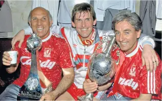  ??  ?? Hero: Kenny Dalglish celebrates the 1990 title with Ronnie Moran (left) and Roy Evans (right)