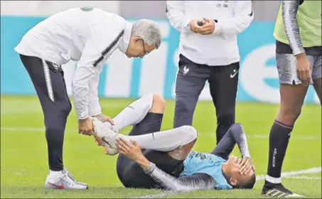  ?? AP ?? ■ France's Kylian Mbappe injured his ankle after a tackle from Adil Rami. The 19yearold forward limped off the training session raising doubts over his World Cup availabili­ty.