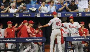  ?? STEVE NESIUS — THE ASSOCIATED PRESS ?? The Phillies greet starting pitcher Jake Arrieta at the dugout as he leaves Saturday’s game against the Rays during the seventh inning Saturday in St. Petersburg, Fla.