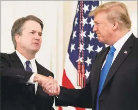  ?? SAUL LOEB / AFP/Getty Images ?? U.S. Judge Brett Kavanaugh shakes hands with President Donald Trump after being nominated to the Supreme Court July 9.