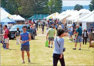  ?? MEDIANEWS GROUP ?? Visitors check out the wares at the Madison-bouckville Antique Week vendors on Wednesday, Aug. 16, 2017.