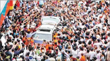  ?? HENG CHIVOAN ?? Mourners surround a vehicle carrying the body of slain political commentato­r Kem Ley during his funeral in July 2016.