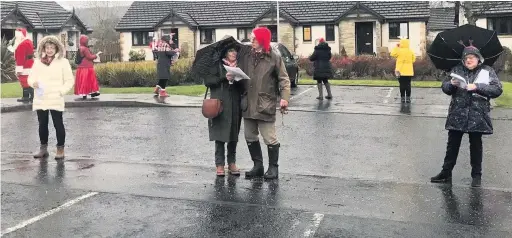  ??  ?? On song The carol singers entertain at Comrie’s Cameron Court