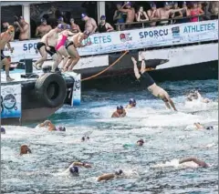  ?? OZAN KOSE/AFP ?? Swimmers jump in the Bosphorous river as they take part in the Bosphorus Cross Continenta­l Swim event on Sunday.