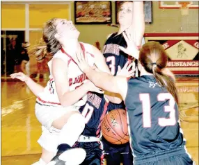  ?? PHOTO BY RICK PECK ?? McDonald County’s Cloee Helm (10) knocks the ball away Aurora’s Emily Moore while Lady Mustang teammates Tricia Wattman (23) and Meagan Mills (13) help out.