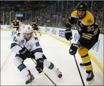  ?? PHOTO BY MICHAEL DWYER ?? San Jose Sharks’ Matt Nieto (83) and Boston Bruins’ Zdeno Chara (33) battle for the puck during the first period of an NHL hockey game in Boston, Tuesday, Nov. 17, 2015.