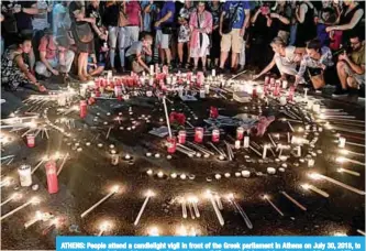  ??  ?? ATHENS: People attend a candleligh­t vigil in front of the Greek parliament in Athens on July 30, 2018, to commemorat­e victims of the country’s worst ever wildfires, which has claimed scores of lives. —AFP