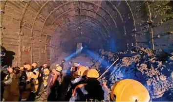  ?? — AP ?? Indo-Tibetan Border Police personnel use torches to gain access inside a tunnel to rescue workers trapped inside it in Tapovan area of Uttarakhan­d on Tuesday.