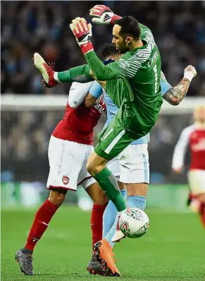  ??  ?? C-r-a-s-h: Manchester City goalkeeper Claudio Bravo (right) clashing with Arsenal striker Pierre-Emerick Aubameyang (left) during the League Cup final at Wembley on Sunday.