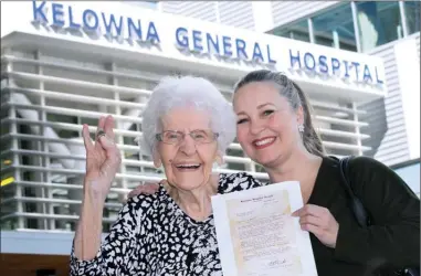  ?? GARY NYLANDER/The Daily Courier ?? Katherine Brown of Kelowna holds up 15 cents to pay a 72-year-old bill held by her granddaugh­ter, Diane Petherioti­s, Wednesday at Kelowna General Hospital. Brown celebrated her 97th birthday by making good a debt she believes was unjustly imposed.