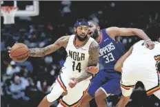  ?? BERT
AP PHOTO/ GERALD HER- ?? New Orleans Pelicans forward Brandon Ingram (14) goes to the basket against LA Clippers forward Nicolas Batum (33) in the first half of an NBA basketball game in New Orleans on Friday.