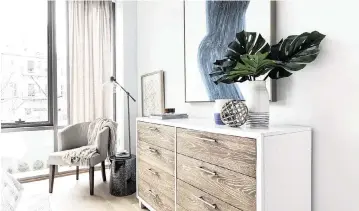  ?? TNS ?? A wood dresser helps to add texture to this bedroom.