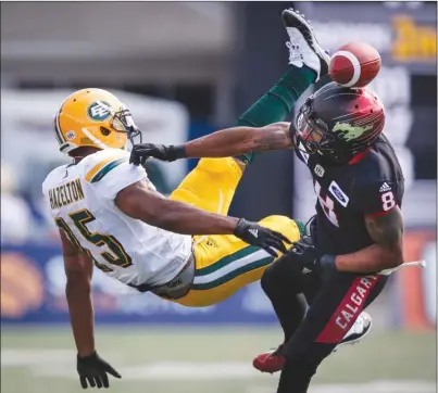  ?? The Canadian Press ?? Calgary Stampeders’ Emanuel Davis, right, knocks a pass away from Edmonton Eskimos’ Vidal Hazelton during second-half CFL action in Calgary on Monday afternoon. The Stampeders won 23-20.