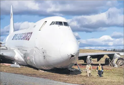  ?? CP FILE PHOTO ?? Transporta­tion Safety Board investigat­ors remove flight data recording equipment from a SkyLease Cargo plane that skidded that off a runway, at Halifax Stanfield Internatio­nal Airport, on Nov. 8.