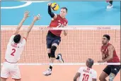  ?? MANU FERNANDEZ — THE ASSOCIATED PRESS ?? David Smith spikes the ball during the United States’ men’s volleyball victory over Tunisia on Wednesday.