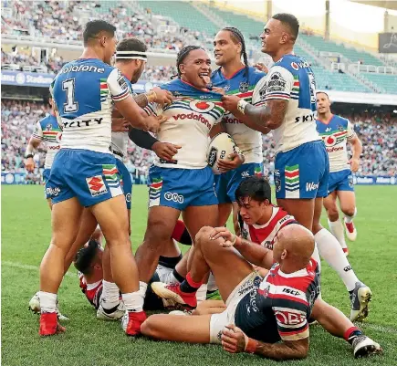  ?? PHOTO: GETTY IMAGES ?? Solomone Kata of the Warriors celebrates with team-mates after scoring a try against the Sydney Roosters at Allianz Stadium on Saturday.