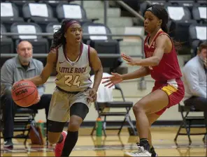  ?? (Photo courtesy UALR Athletics) ?? UALR guard Mayra Caicedo (left) handles the ball against a Louisiana-Monroe defender Friday during the Trojans’ 71-36 victory over the Warhawks at the Jack Stephens Center in Little Rock. Caicedo had a school-record 17 assists, which is the most in a single game by any player in the country this season.