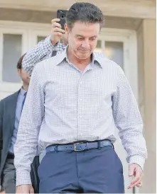  ??  ?? Louisville men’s basketball coach Rick Pitino leaves the school after meetings Wednesday.