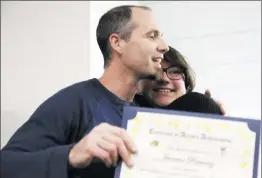  ?? Nikolas Samuels/The
Signal ?? Second-place winner Jasmine Ramirez hugs her Saugus High School art teacher ,Dan Nickels, after receiving her award from the Santa Clarita Valley Mayor’s Committee for Employment of Individual­s with Disabiliti­es at AMS Fulfillmen­t in Valencia on...