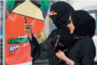 ?? AFP ?? A Saudi woman films using her mobile during the first ever Comic-Con event in the coastal City of Jeddah. —