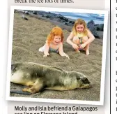  ??  ?? Molly and Isla befriend a Galapagos sea lion on Floreana Island