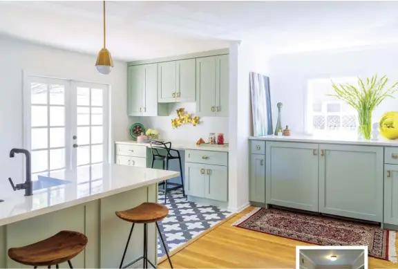  ??  ?? This alcove sits right next to the kitchen and stores the washer and dryer. The cabinet doors hide the machines and provide pullout drawers for laundry supplies. With the flat countertop, this space doubles as a buffet area during friends’ and family...