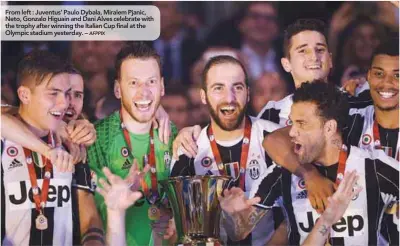  ??  ?? From left : Juventus’ Paulo Dybala, Miralem Pjanic, Neto, Gonzalo Higuain and Dani Alves celebrate with the trophy after winning the Italian Cup final at the Olympic stadium yesterday. –