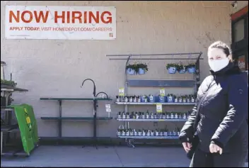  ?? ASSOCIATED PRESS ?? A hiring sign adorns the outside home improvemen­t store in Mount Prospect, Ill. America’s employers unleashed a burst of hiring in March, adding 916,000 jobs in a sign that a sustained recovery from the pandemic recession is taking hold.