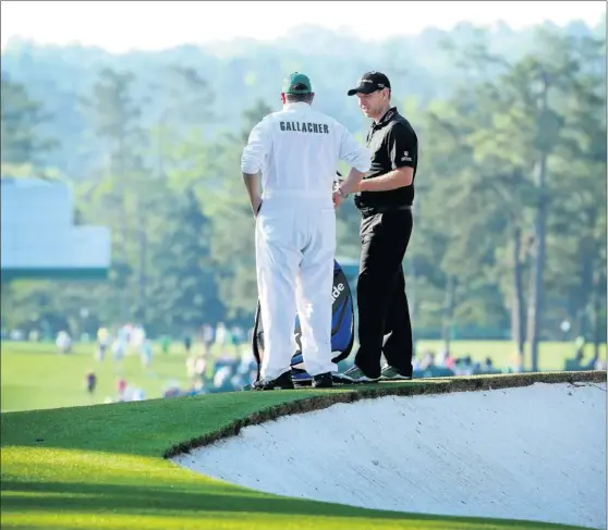  ?? Picture: Getty Sport ?? IT’S GOOD TO TALK: Stephen Gallacher discusses his next shot with caddie Damian Moore on his way to a making par on the second day at Augusta.