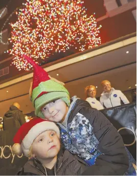  ?? STAFF FILE PHOTOS BY NICOLAUS CZARNECKI ?? Brady Cushman, above right, and brother Logan of Peabody enjoyed last year’s Macy’s Christmas Tree lighting in Downtown Crossing, complete with a Santa Claus sighting, left.