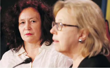  ?? TONY CALDWELL ?? Elizabeth May, right, leader of the federal Green Party, addresses an appeal to Prime Minister Justin Trudeau for granting asylum to Russian scientist Elena Musikhina, left, at Parliament Hill on Wednesday. Musikhina fears she will be a victim of an “accident” if sent back to Russia.